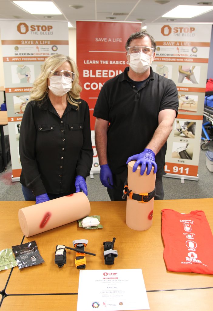 Two people at a TBRHSC Trauma Program booth at an event
